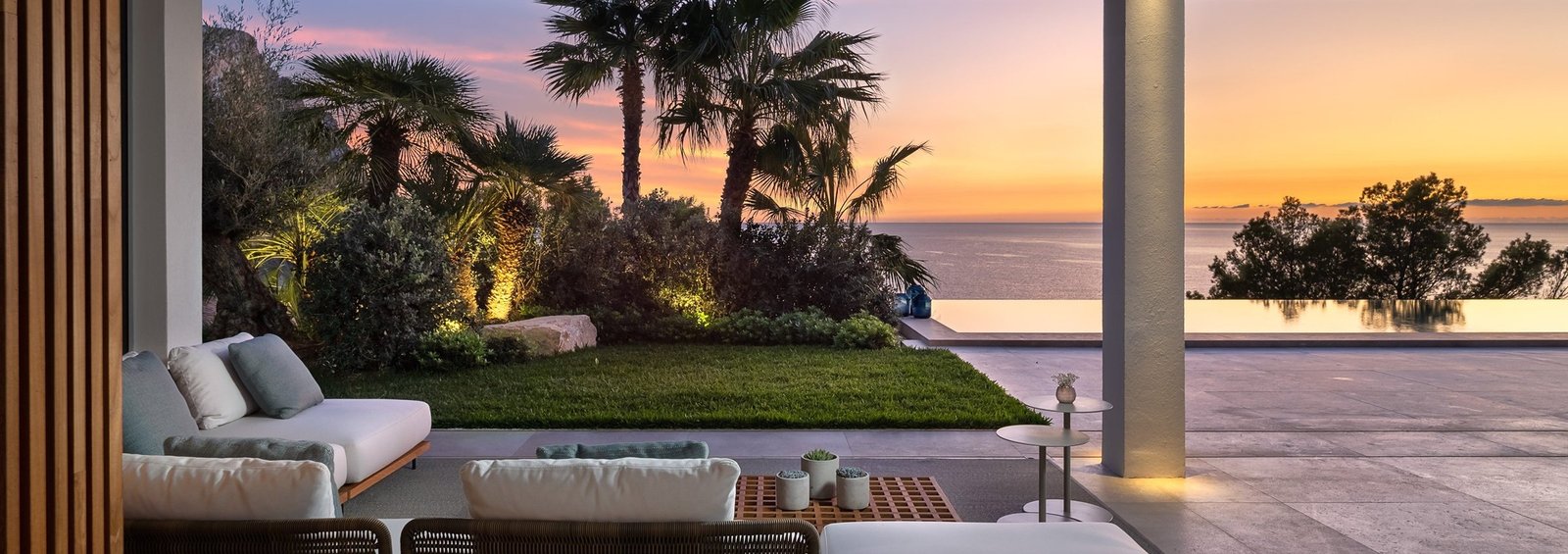 Garden with palm trees and lighting at sunset in a Mallorca villa