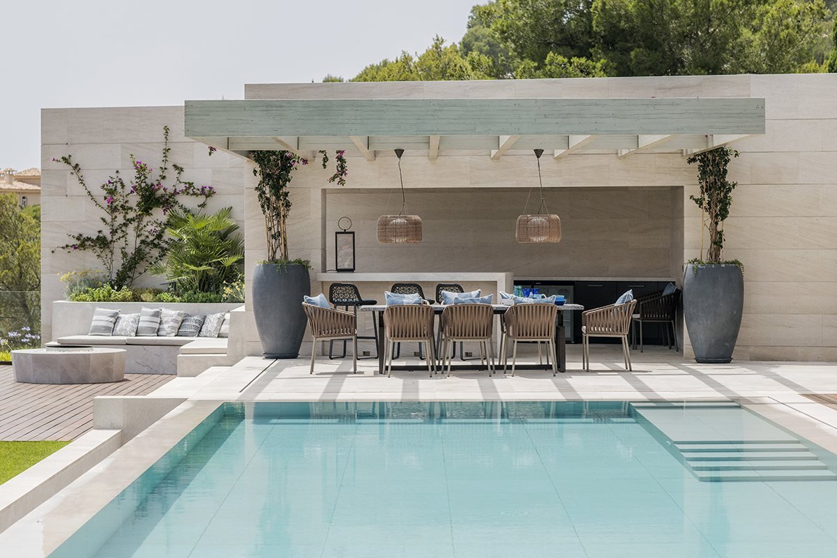 Swimming pool with pergola and outdoor dining area in a Mallorca villa