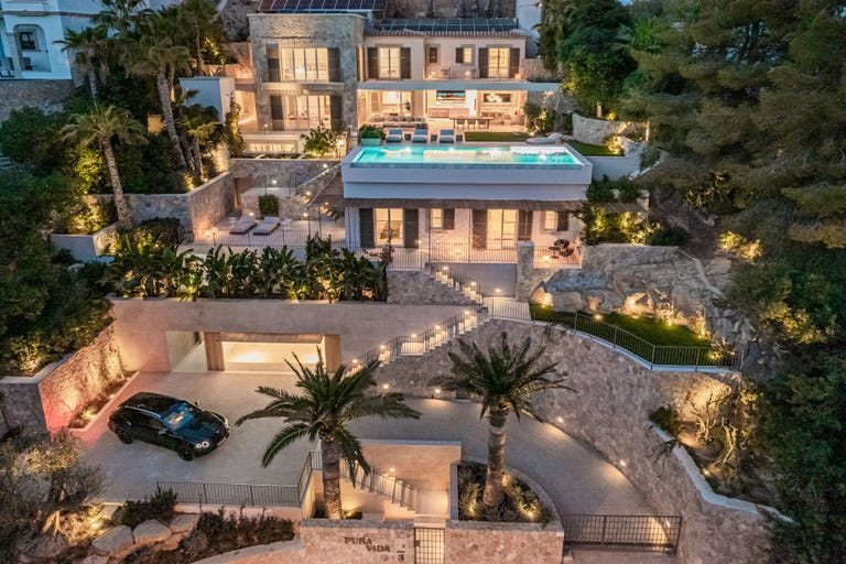Luxury villa with illuminated garden and pool at dusk, Mallorca